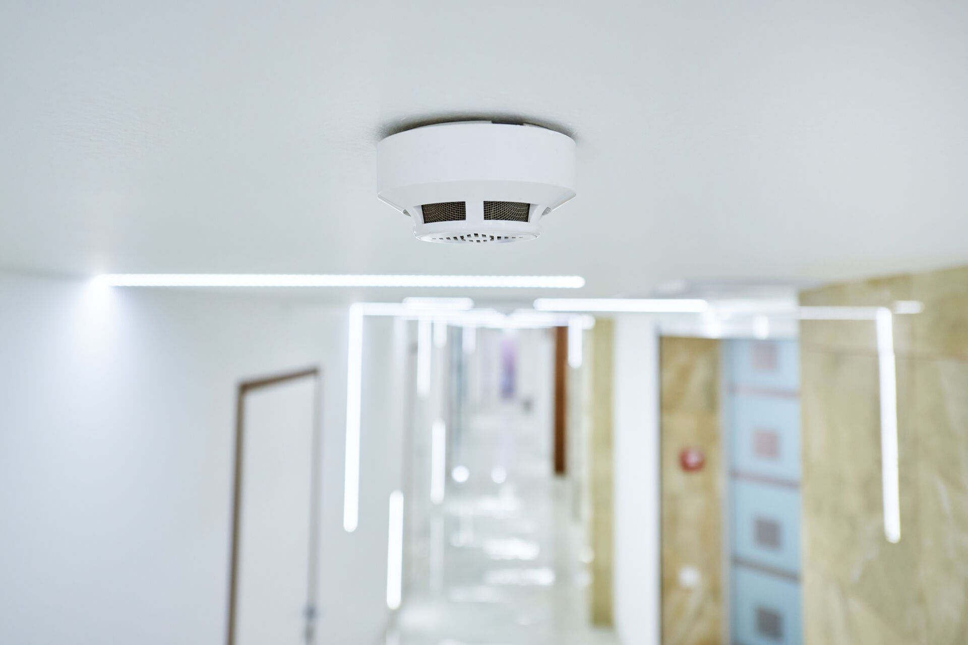 Local Maintenance Services installing smoke alarm in property